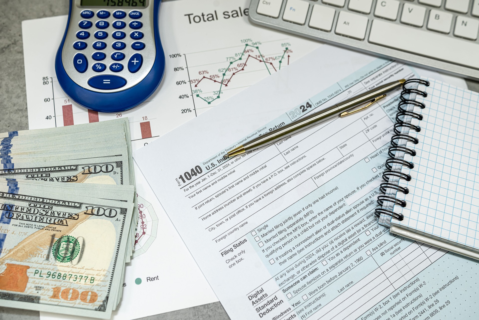 us 1040 tax forms, laptop keyboard and calculator money dollar bills, business tax time concept